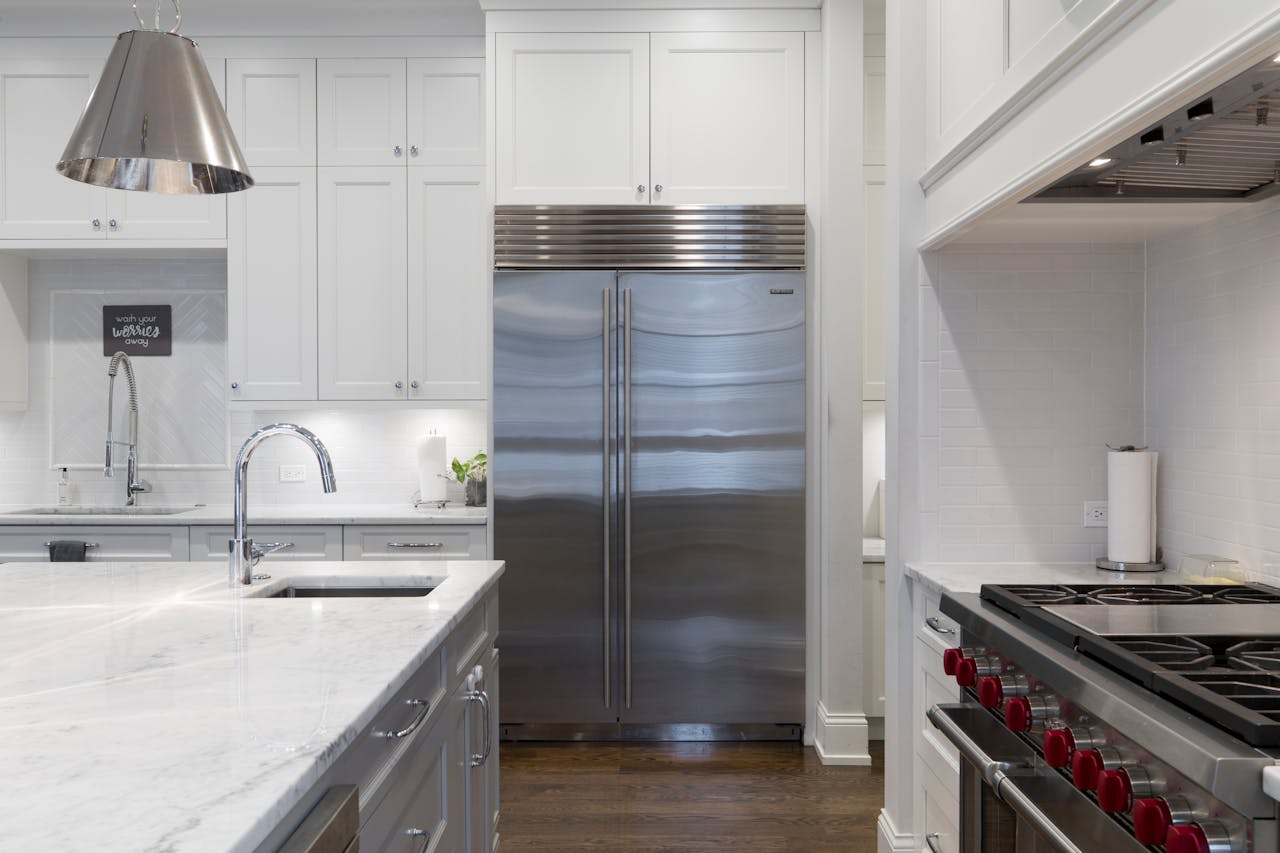 hero-img A sleek modern kitchen featuring stainless steel appliances and marble countertops.